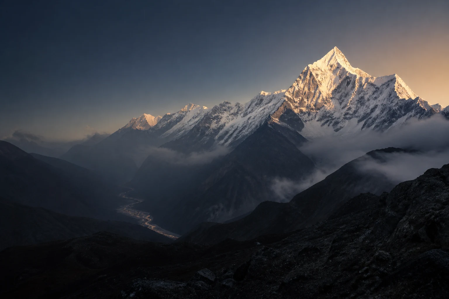 Sunrise illuminating a snow-covered Himalayan mountain range